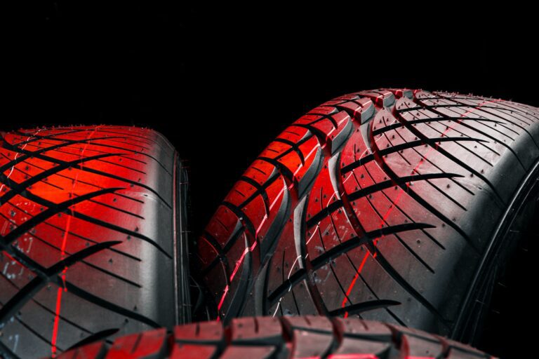 A pair of tires on a black background at HiTech Automotive of Brandon